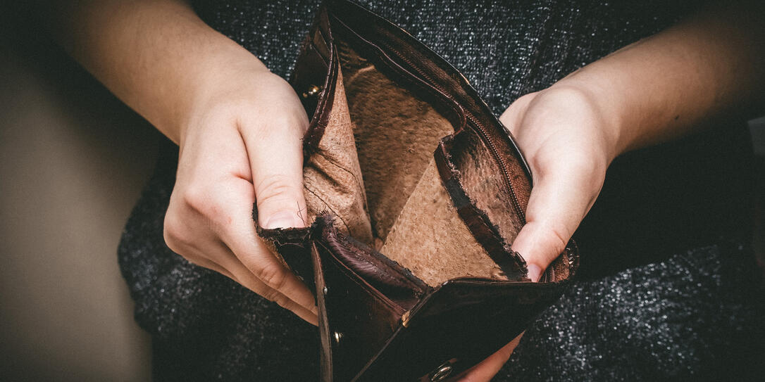 Old empty wallet in the hands .Vintage empty purse in hands of women . Poverty concept, Retirement. Special toning