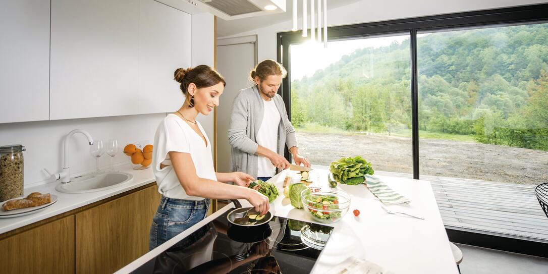 Couple cooking food at the kitchen home
