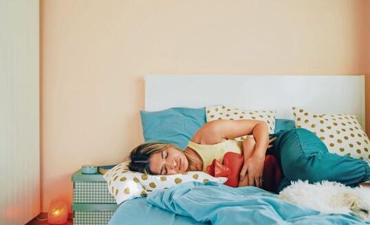 Woman with stomach pain staying home