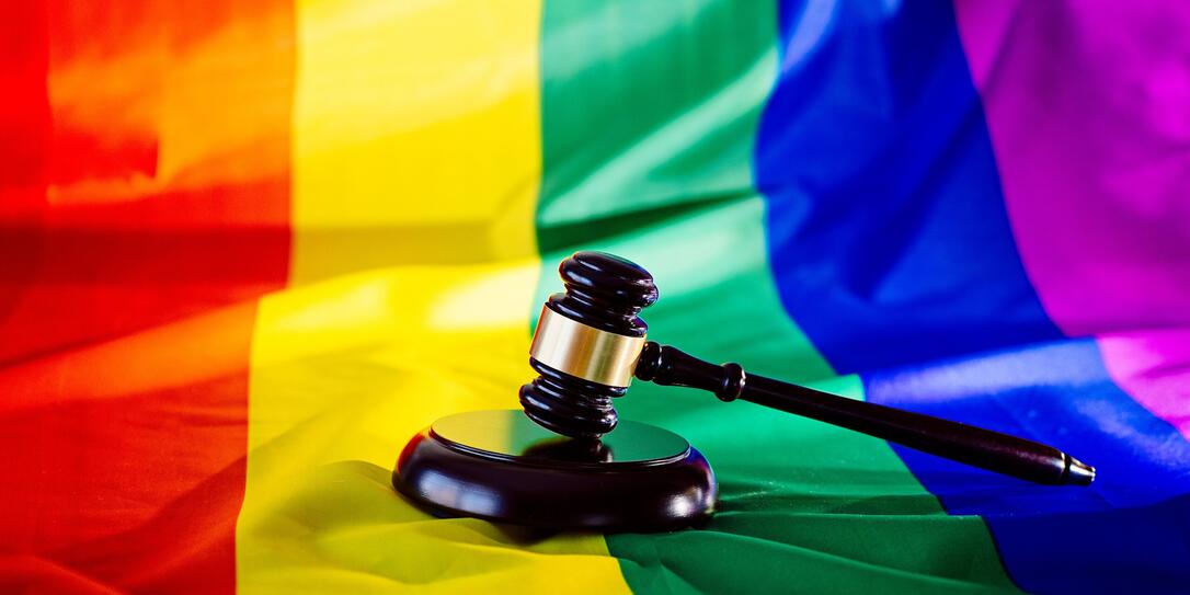 Woden judge mallet symbol of law and justice with lgbt flag