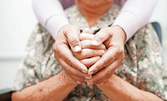 Caregiver holding hands Asian elderly woman patient, help and care in hospital.