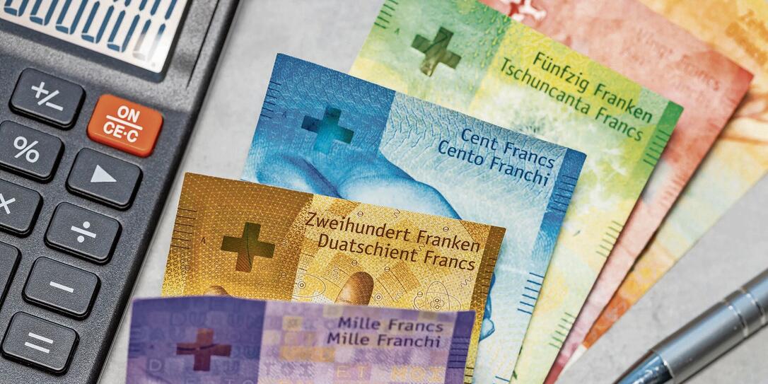 Switzerland money. Swiss francs on gray tabletop. Financial background. Banknotes and calculator. Swiss business concept. Copy space, close up. flat lay