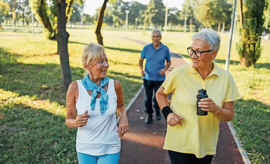 Seniors jogging in park