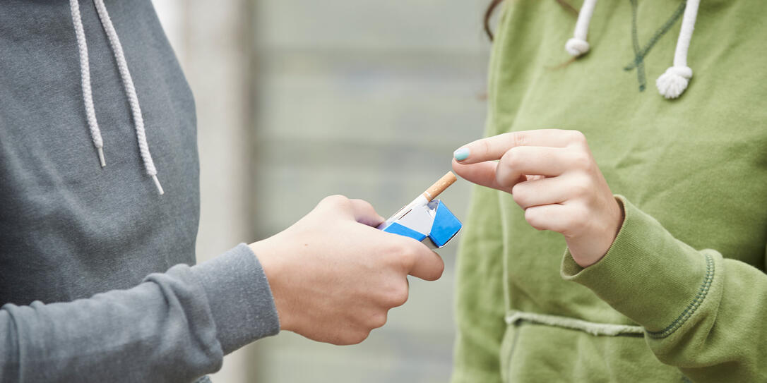 Close Up Of Teenager Boy Offering Girl Cigarette