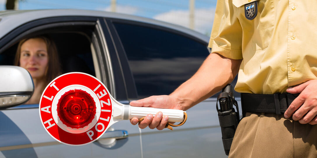 Policemen or cop stop car holding a sign that says halt