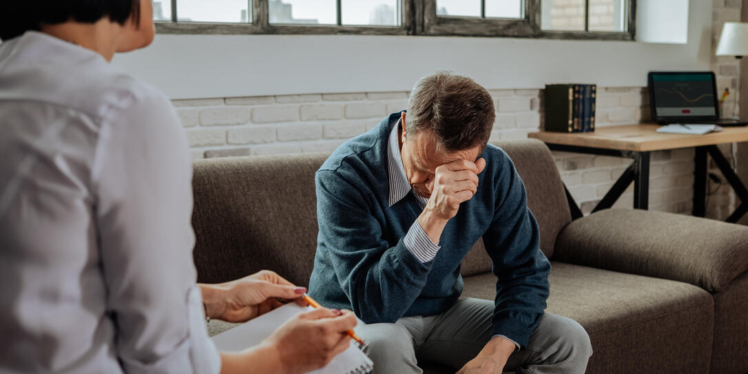 Despaired short-haired patient having mental issues and explaining them