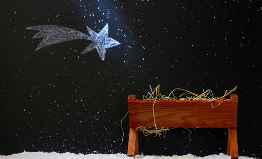 Manger and star of Bethlehem on snowy night, abstract christmas nativity scene concept