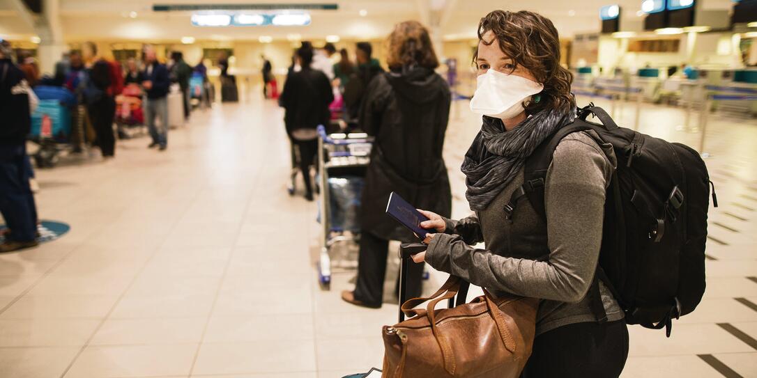 At the airport with a face mask