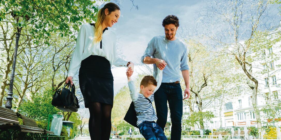 Happy Family Walking Through The Park Taking Son to School