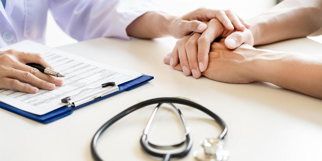 Midsection Of Doctor Consoling Patient In Hospital