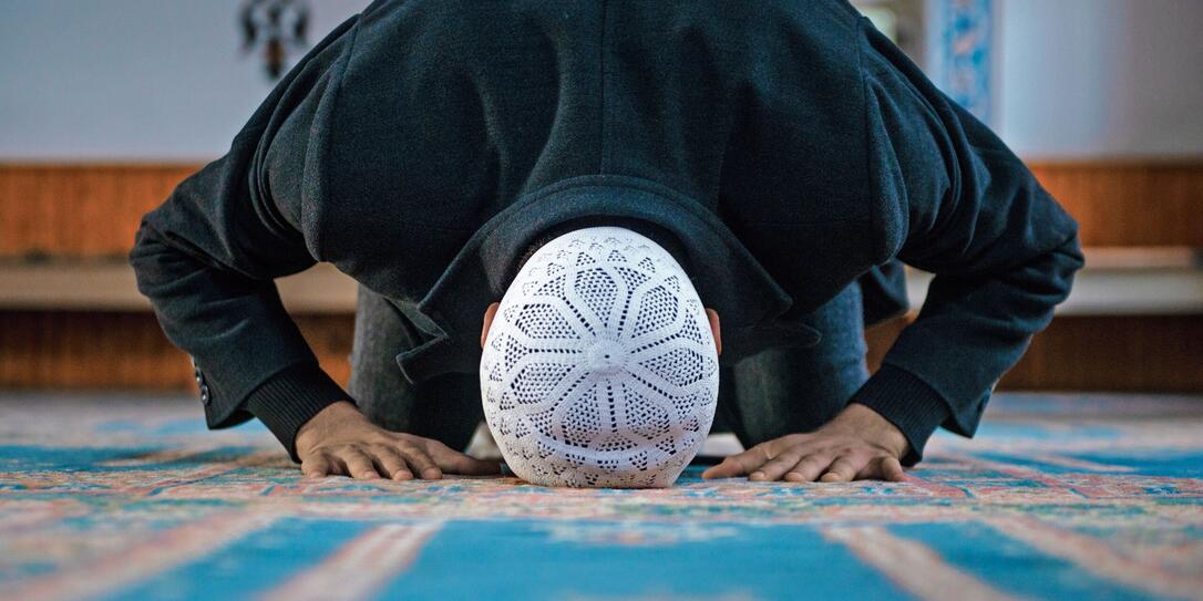 Close-up shot of a Muslim young man worshiping in a mosque Close-up shot of a Muslim young man worshiping in a mosque