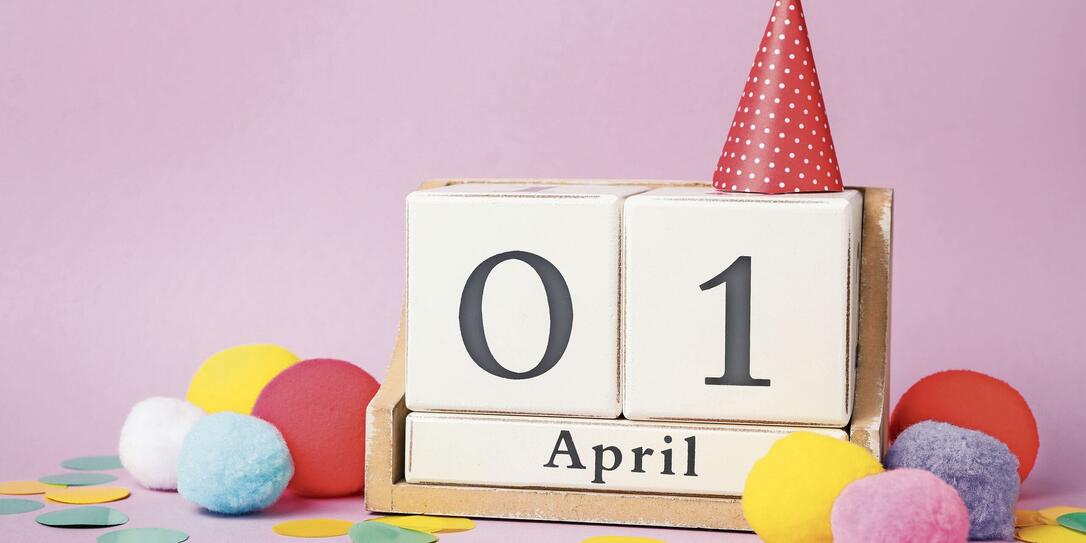 Wooden block calendar and party decor on violet background. April fool's day Wooden block calendar and party decor on violet background. April fool's day