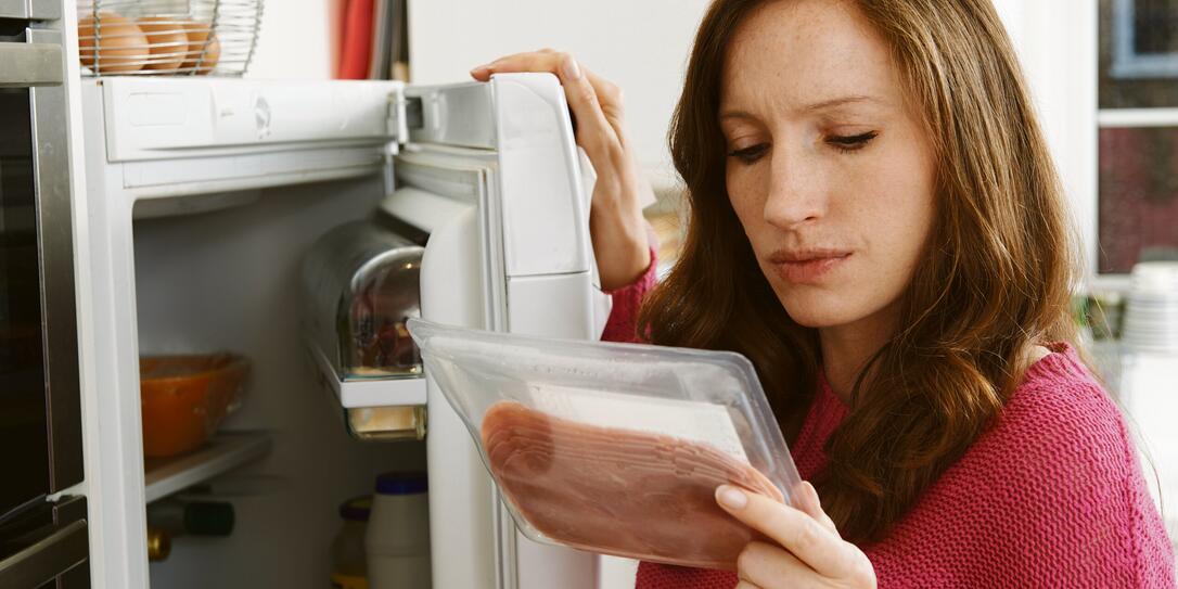 Concerned Woman Looking At Pre Packaged Meat Concerned Woman Looking At Pre Packaged Meat