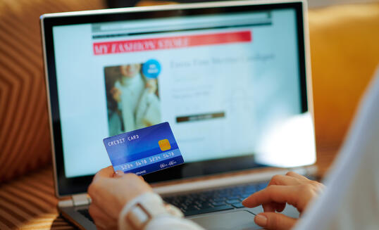 Closeup on woman ordering sweater in fashion online shop