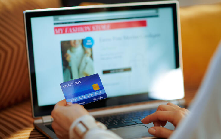 Closeup on woman ordering sweater in fashion online shop