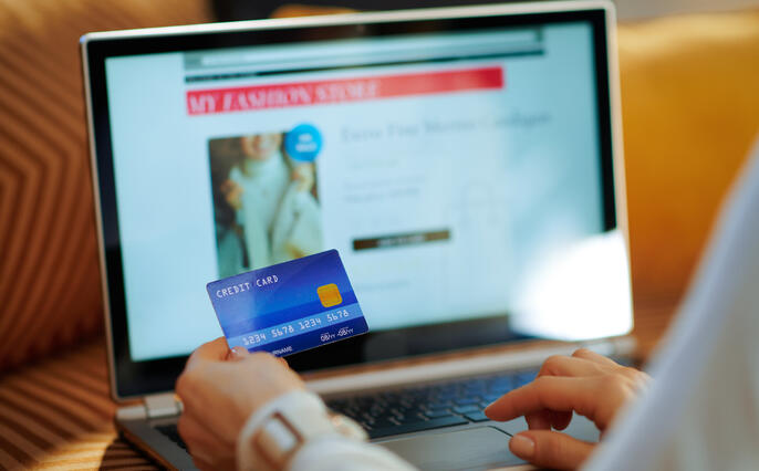 Closeup on woman ordering sweater in fashion online shop