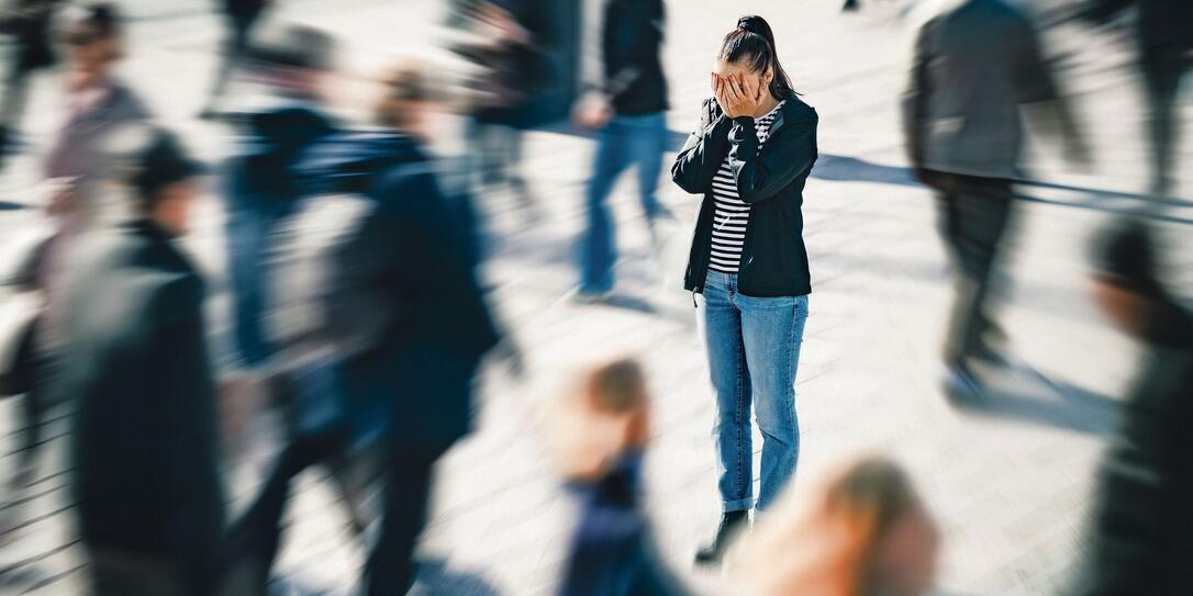 Stress, anxiety, fear or panic attack in public. Depressed woman with mental health disorder or schizophrenia. Phobia of crowd of people. Introvert person in busy city street.