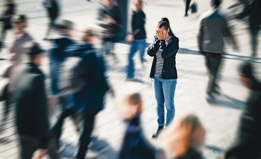 Stress, anxiety, fear or panic attack in public. Depressed woman with mental health disorder or schizophrenia. Phobia of crowd of people. Introvert person in busy city street.