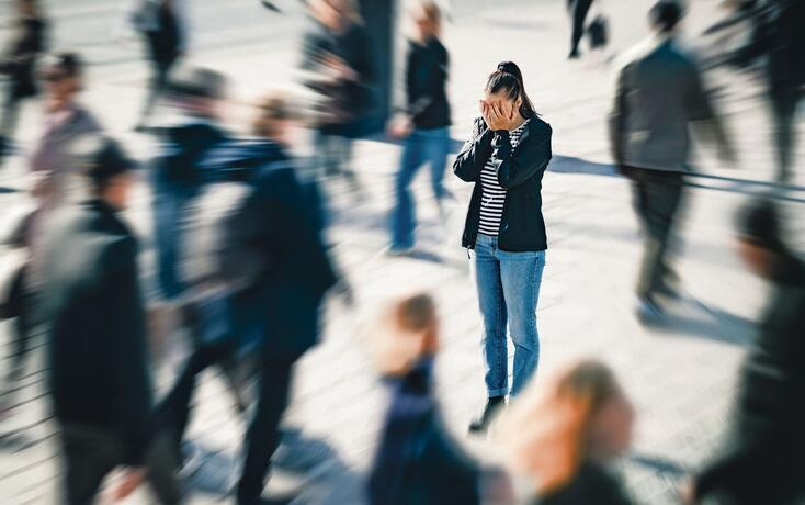 Stress, anxiety, fear or panic attack in public. Depressed woman with mental health disorder or schizophrenia. Phobia of crowd of people. Introvert person in busy city street.