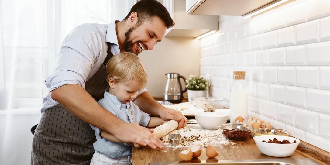 happy family in kitchen. father and child baking cookies