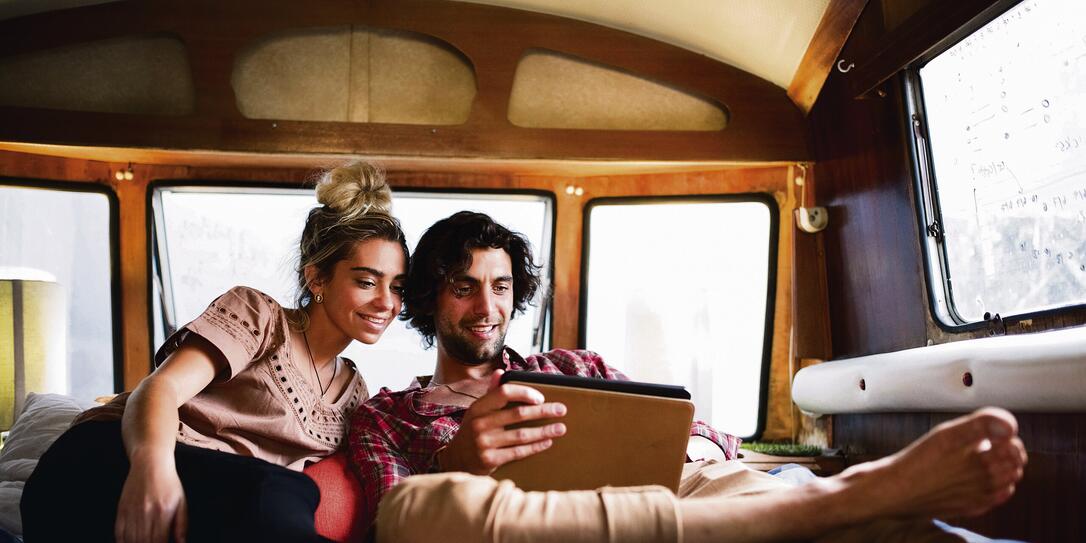 Couple watching movie on tablet in motor home