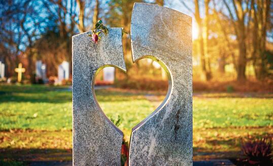 Gravestone with heart withered rose
