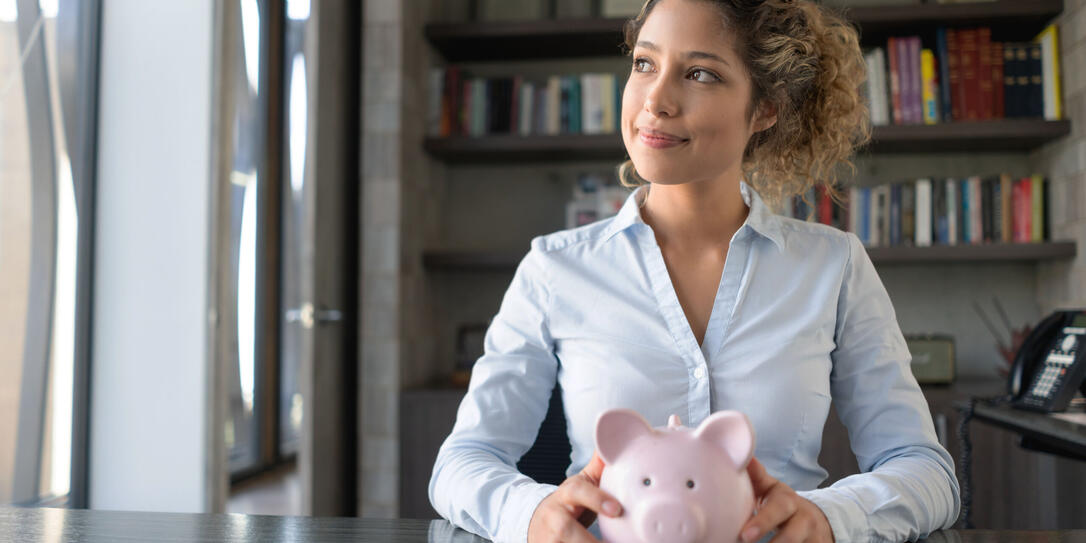 Business woman thinking how to spend her savings Business woman thinking how to spend her savings