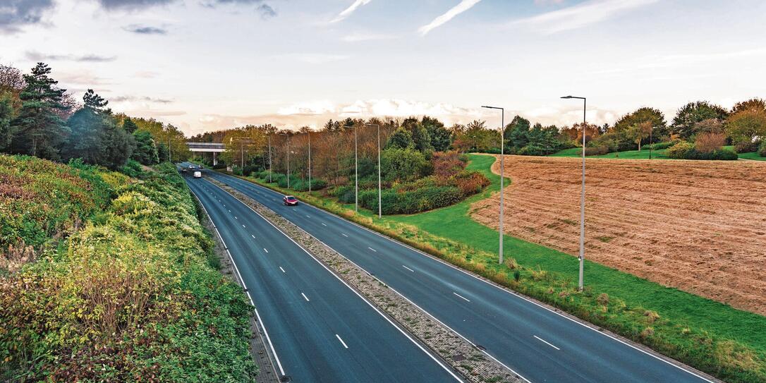 Road with car traffic crossing beautiful country land Road with car traffic crossing beautiful country land