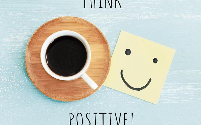 A cup of coffee with the text think positive