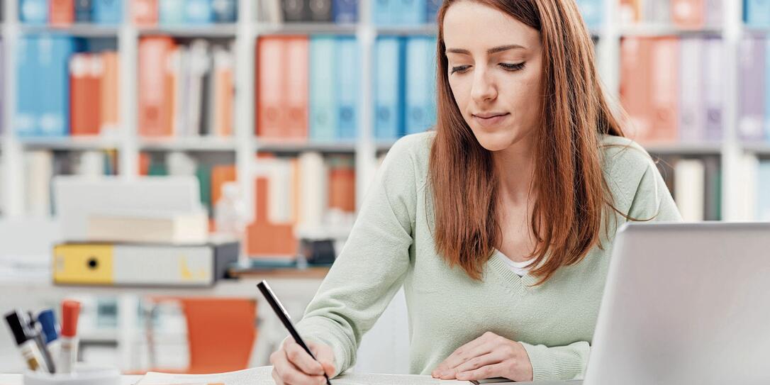 University student reading a textbook University student reading a textbook