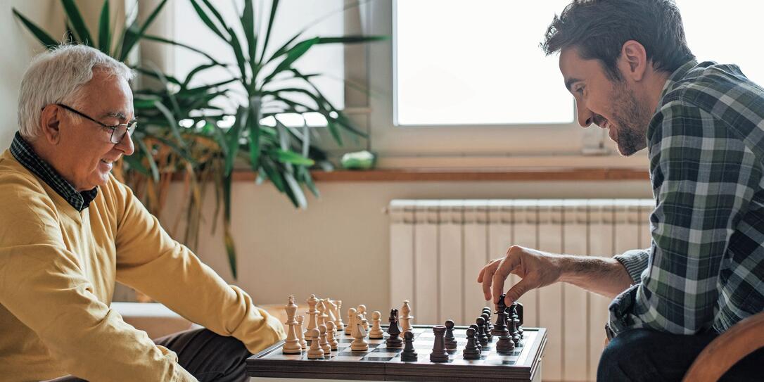 Happy men playing chess