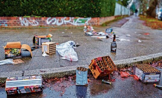 Remains of a New Year's Eve celebration on a sidewalk.