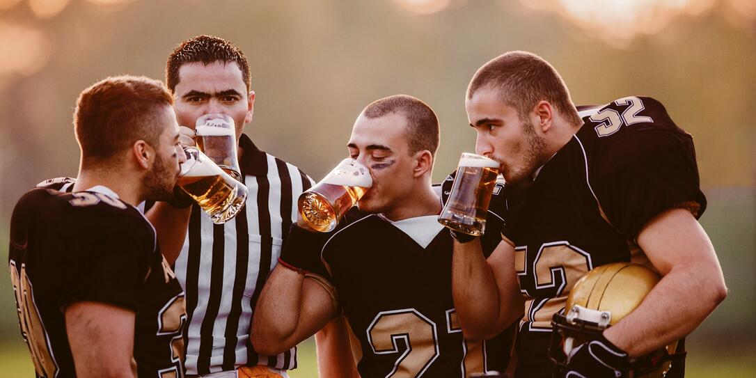 American Football Players drinking beer.