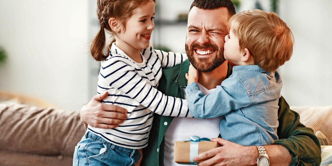 Happy father getting congratulations from kids