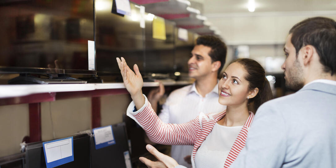 Young people purchasing television set
